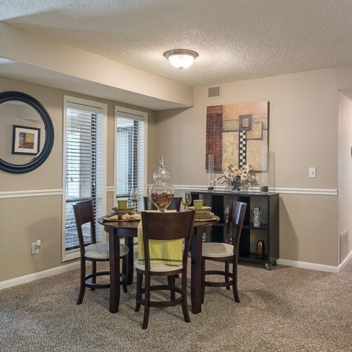 a dining room with a large table and chairs