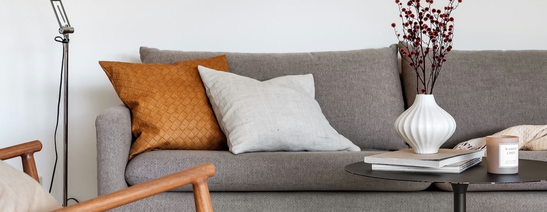 a couch with a lamp and a painting on the wall